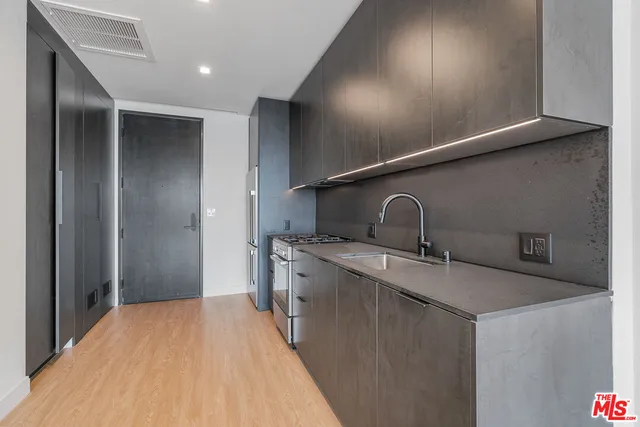 a kitchen with a sink and refrigerator