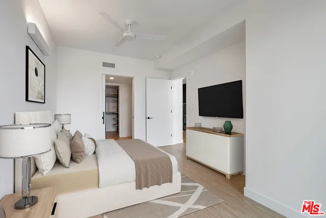 a bedroom with a bed and a flat screen tv