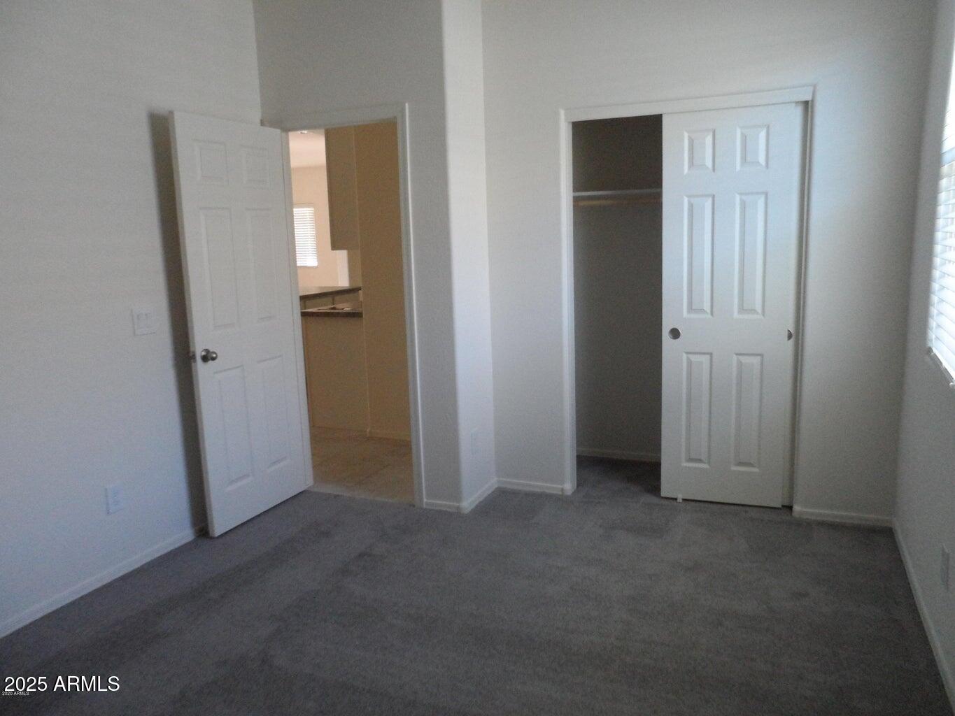11618 West Boca Raton Road El Mirage, AZ 85335 - Photo 12 of 14 an empty room with windows