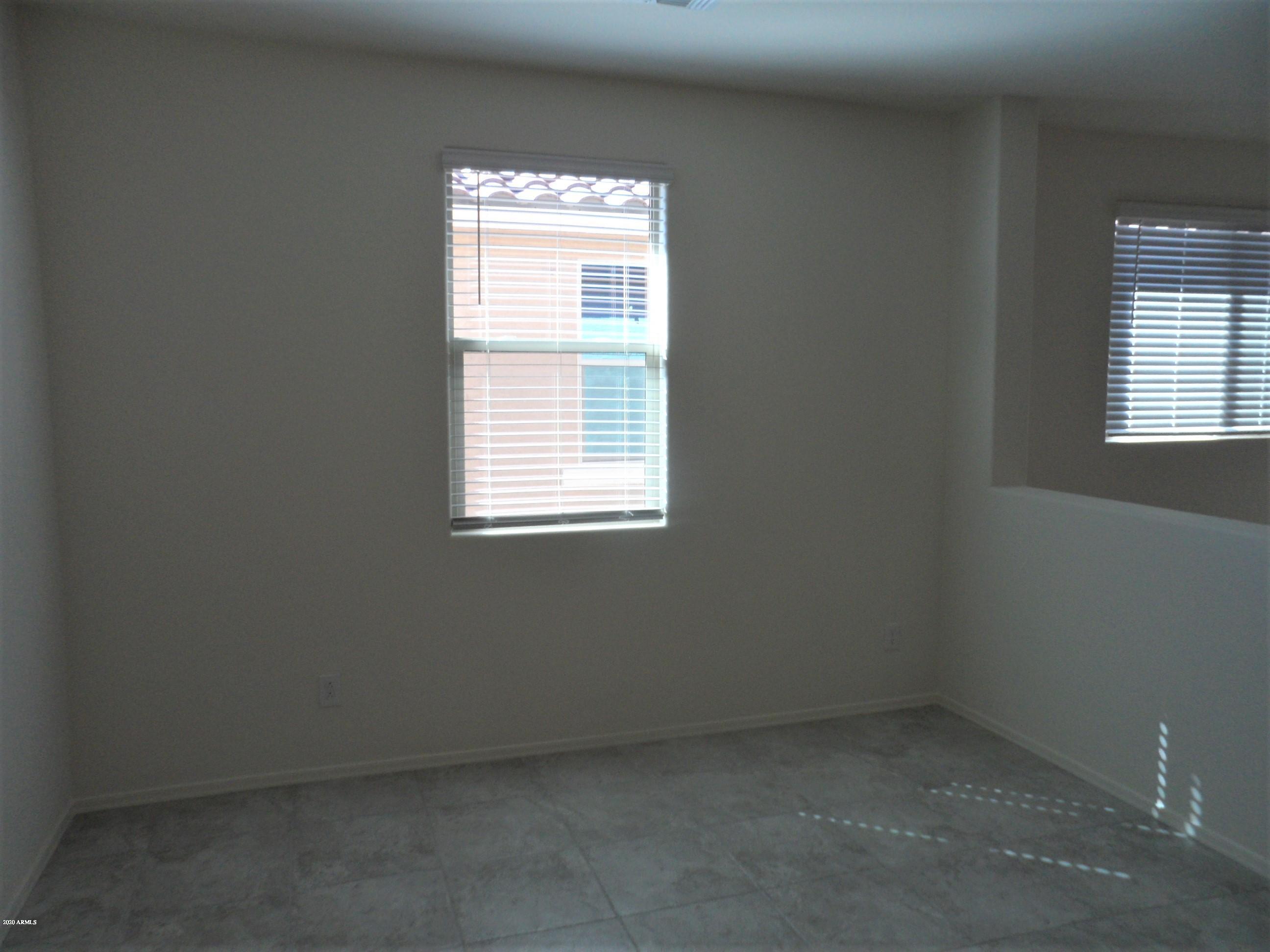 11618 West Boca Raton Road El Mirage, AZ 85335 - Photo 4 of 14 an empty room with a window
