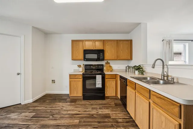 a kitchen with stainless steel appliances granite countertop a stove a sink and a microwave