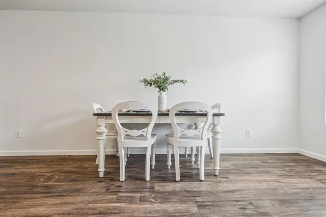 a dining room with furniture wooden floor and a potted plant