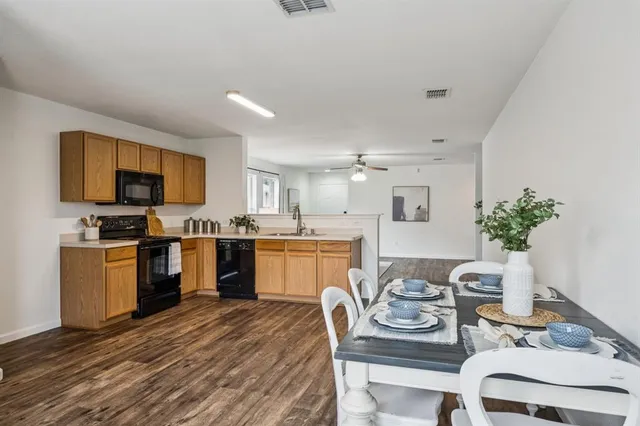 a kitchen with kitchen island granite countertop lots of counter top space and stainless steel appliances
