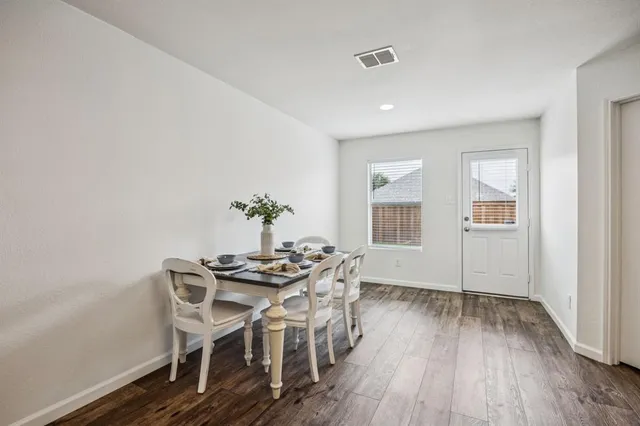 a view of a dining room with furniture and wooden floor