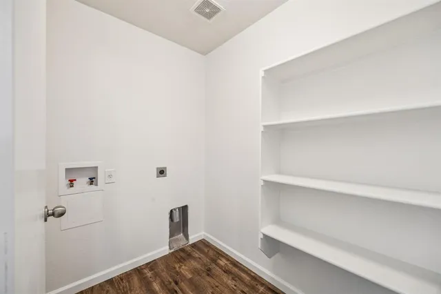 a view of a room with wooden floor