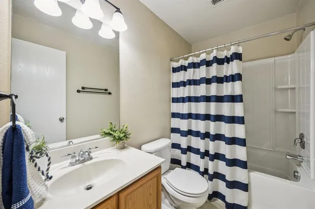 a bathroom with a sink a toilet a shower and a mirror