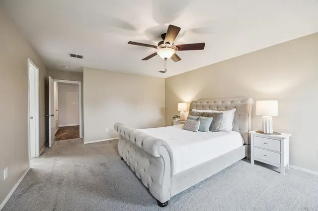 a bedroom with a bed and a ceiling fan