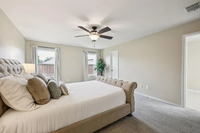 a bedroom with a bed and window