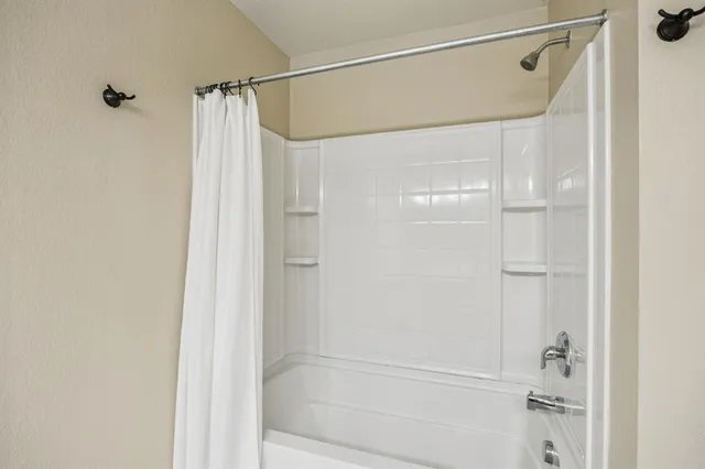 a bathroom with a glass shower door