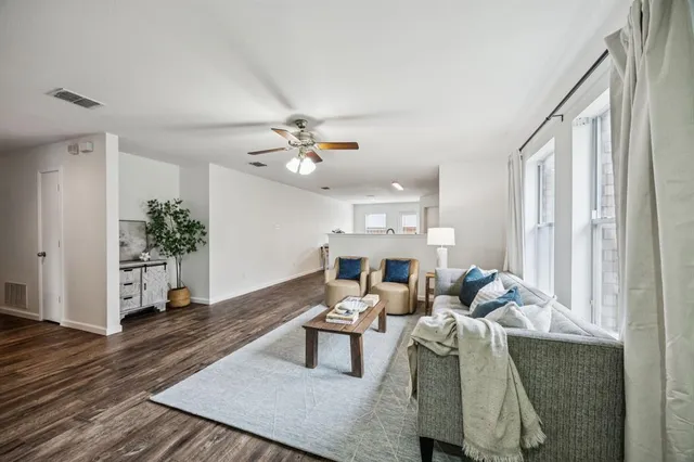 a living room with furniture and a chandelier