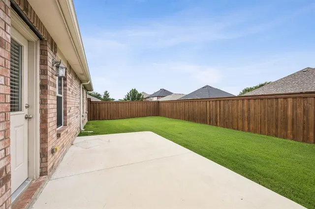 a view of an entrance to house with yard