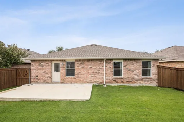 a front view of house with yard and outdoor seating