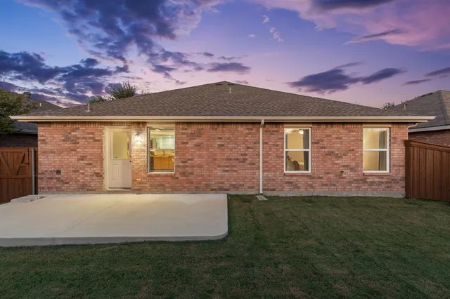 a front view of a house with a garden and yard