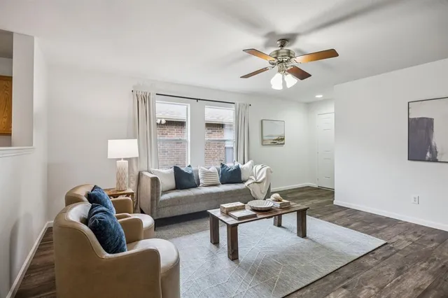 a living room with furniture a chandelier and a window