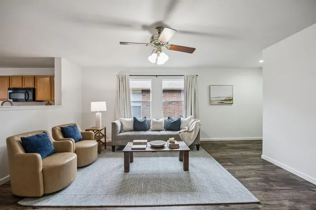 a living room with furniture rug and window