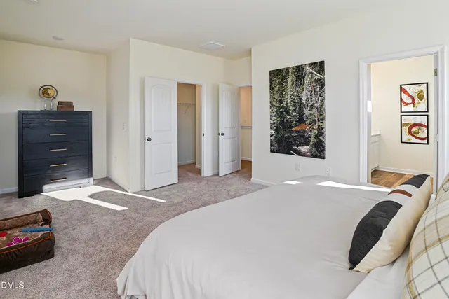 a bedroom with a bed and a television