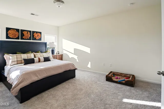 a bedroom with bed and window