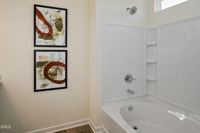 a bathroom with a bathtub and shower
