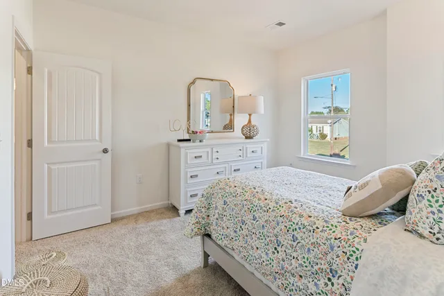 a bedroom with a bed and a dresser