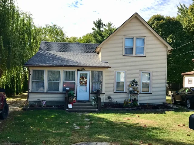 a view of a house with swimming pool next to a yard
