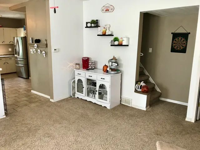 a kitchen with stainless steel appliances a sink cabinets and wooden floor