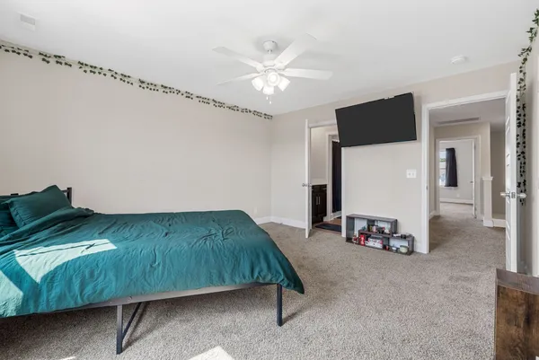 a bedroom with a bed and a chandelier