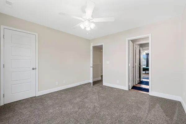 a view of an empty room with a ceiling fan