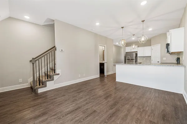 a view of kitchen with wooden floor and electronic appliances