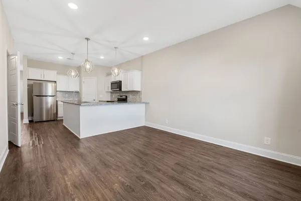 a kitchen with stainless steel appliances a refrigerator sink and microwave