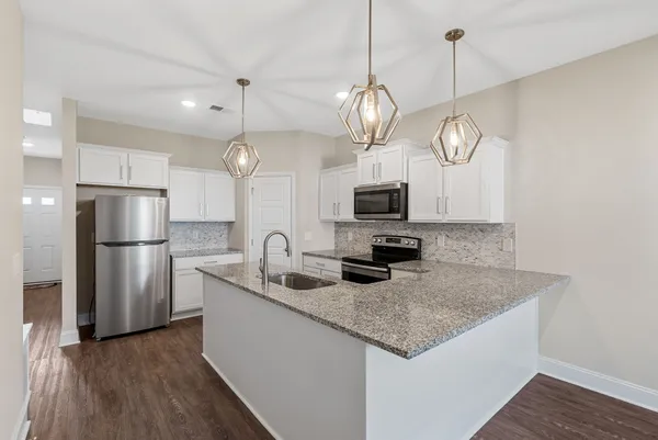 a kitchen with refrigerator and microwave