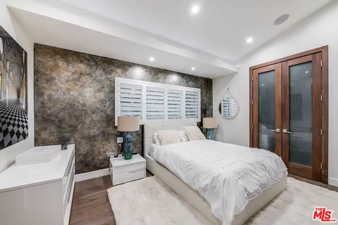 a bedroom with a bed and glass window