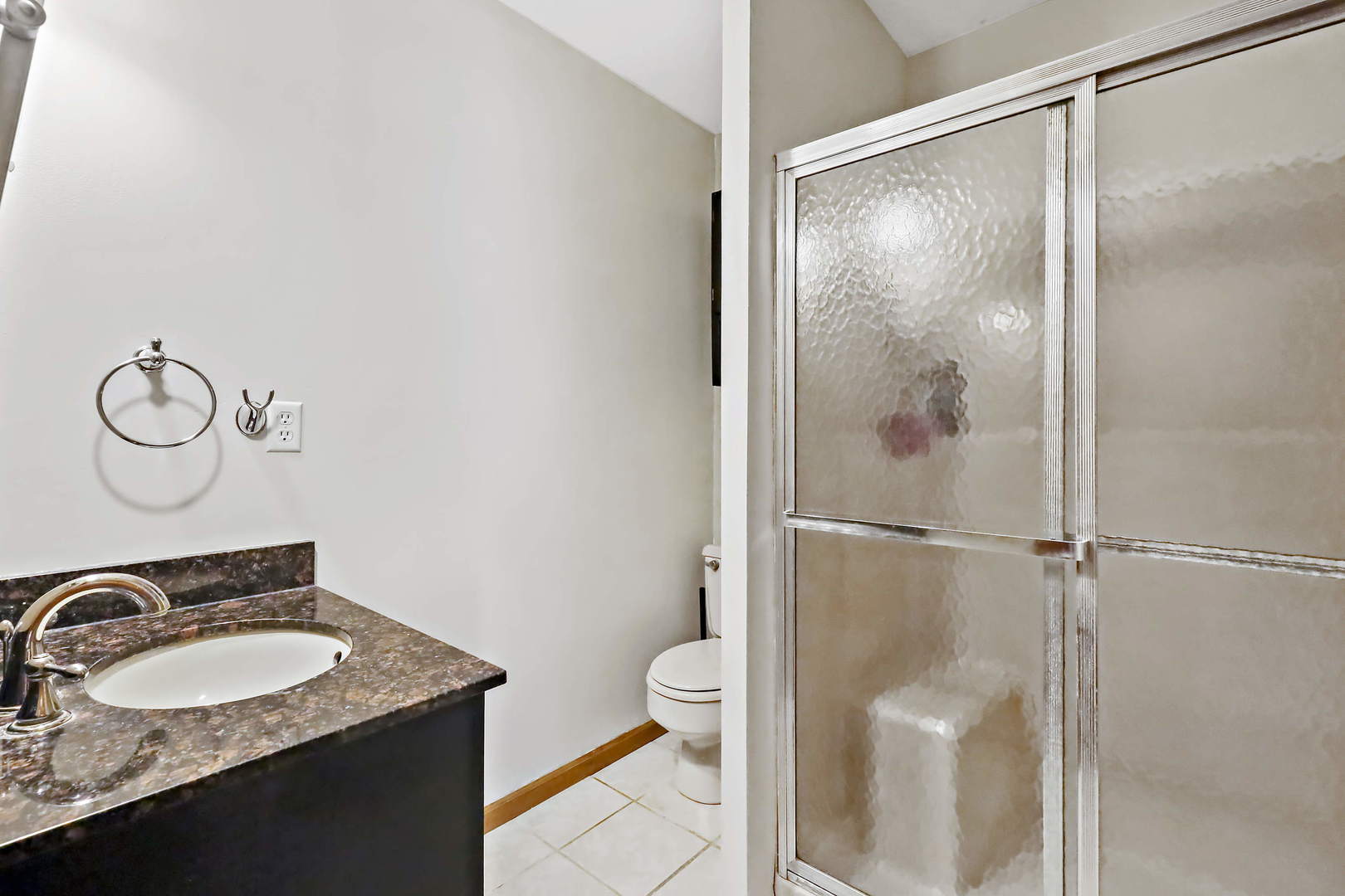 3N118 Howard Road Maple Park, IL 60151 - Photo 10 of 28 a bathroom with a granite countertop sink toilet and shower