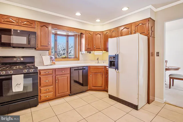 a kitchen with stainless steel appliances a refrigerator sink and microwave