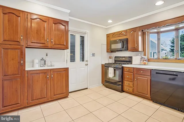 a kitchen with stainless steel appliances granite countertop a refrigerator and wooden cabinets