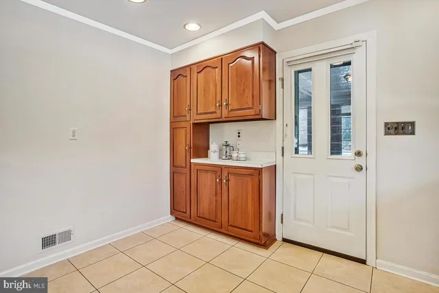 a view of kitchen with granite countertop cabinets and sink