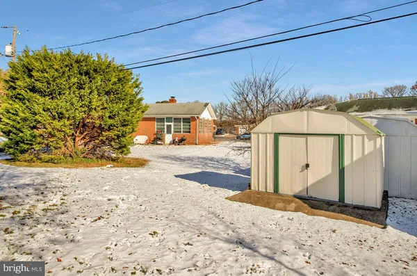 a view of a house with a snow on the road