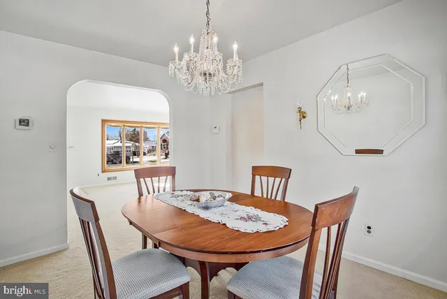 a view of a dining room with furniture and chandelier