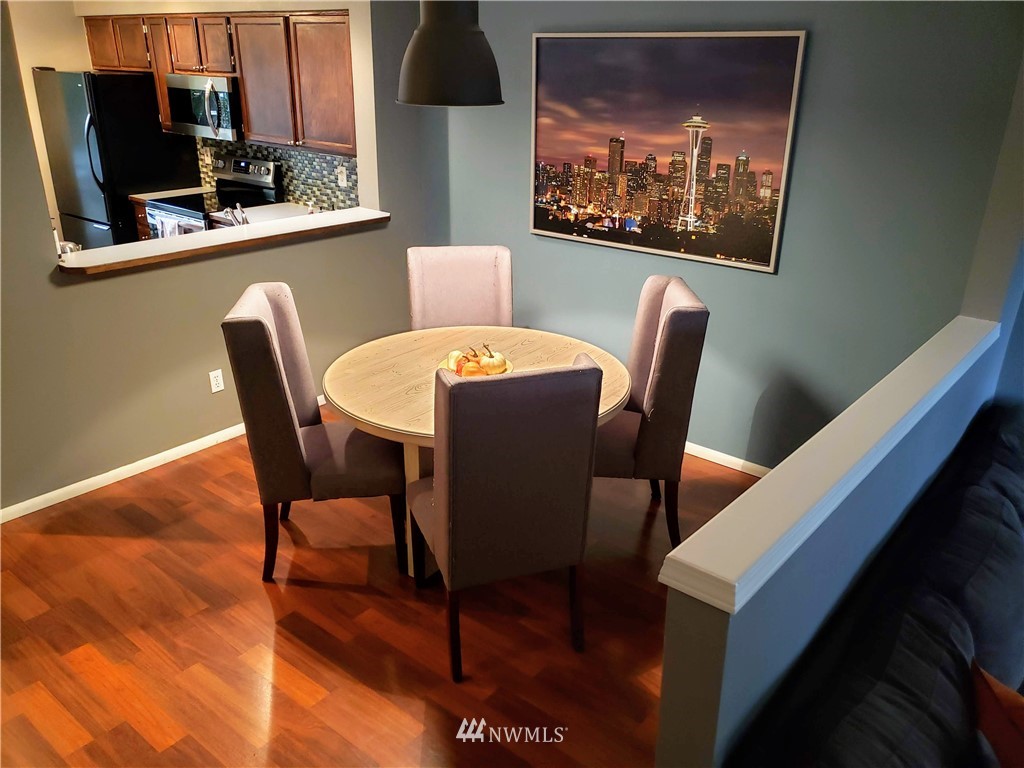 833 Southwest Sunset Boulevard, Unit B7 Renton, WA 98057 - Photo 11 of 33 a dining room with furniture and wooden floor