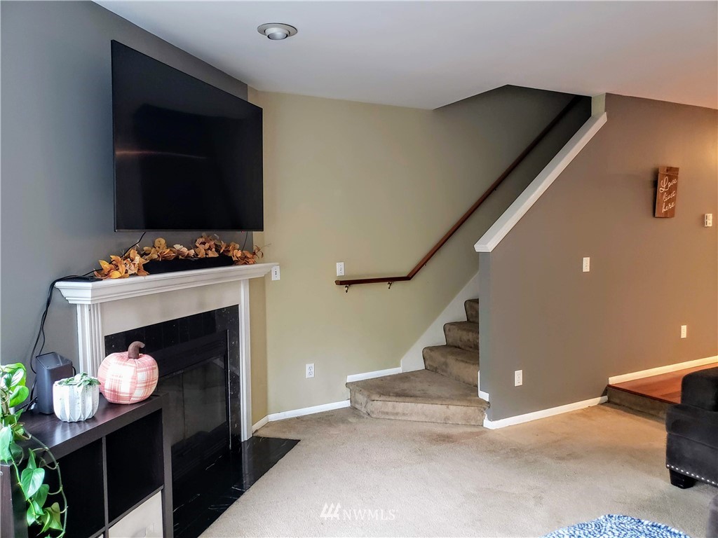 833 Southwest Sunset Boulevard, Unit B7 Renton, WA 98057 - Photo 16 of 33 a living room with furniture and a fireplace