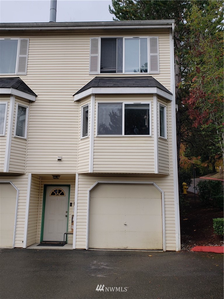 833 Southwest Sunset Boulevard, Unit B7 Renton, WA 98057 - Photo 3 of 33 a front view of a house with a garage