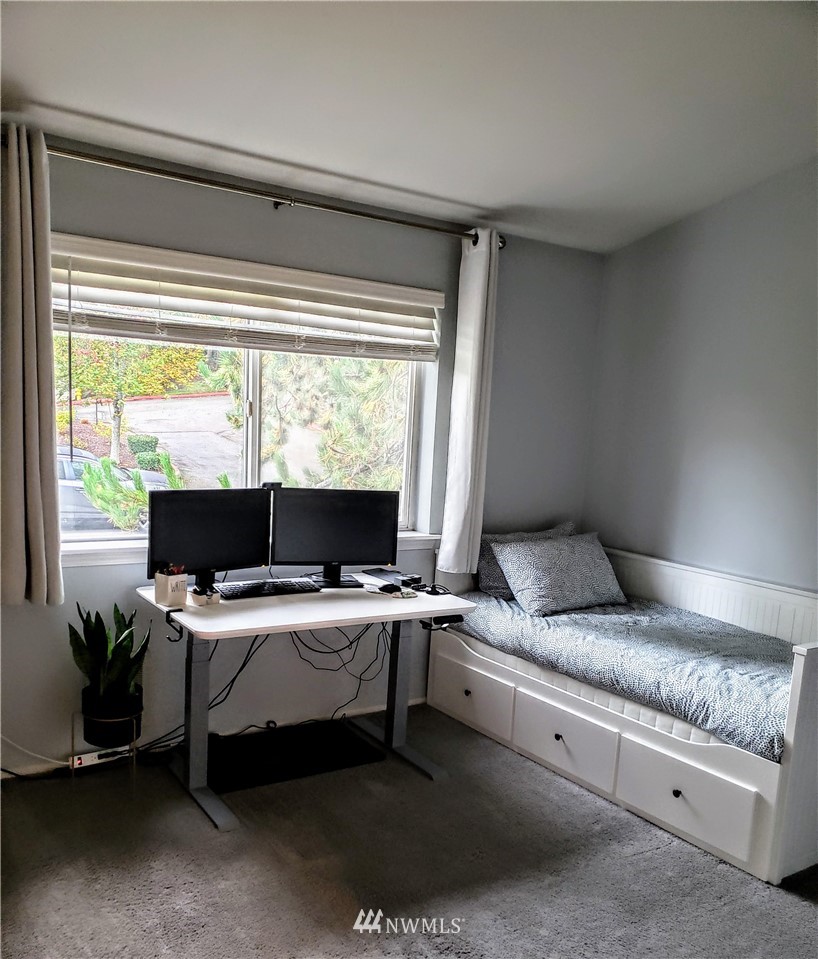 833 Southwest Sunset Boulevard, Unit B7 Renton, WA 98057 - Photo 23 of 33 a room with a bed and large windows