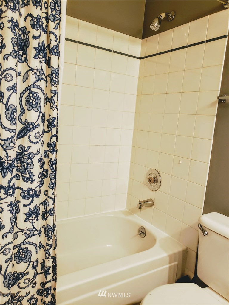 833 Southwest Sunset Boulevard, Unit B7 Renton, WA 98057 - Photo 26 of 33 a bathroom with a bathtub and shower