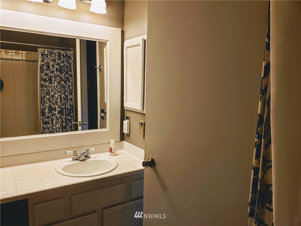833 Southwest Sunset Boulevard, Unit B7 Renton, WA 98057 - Photo 27 of 33 a bathroom with a sink and a mirror