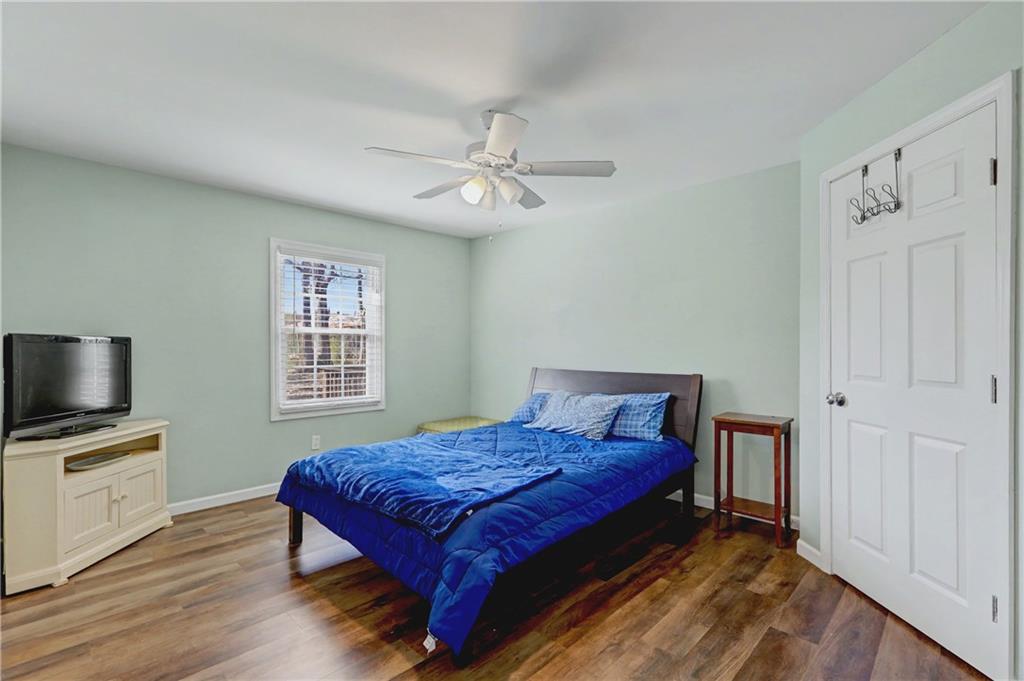 134 Church Road Thomaston, GA 30286 - Photo 12 of 33 a spacious bedroom with a bed and a flat screen tv