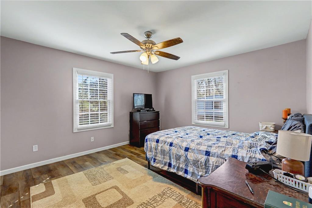 134 Church Road Thomaston, GA 30286 - Photo 18 of 33 a bedroom with a bed and a chandelier