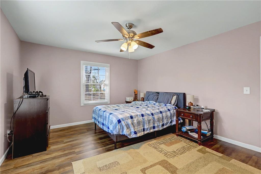 134 Church Road Thomaston, GA 30286 - Photo 19 of 33 a bedroom with a bed and wooden floor