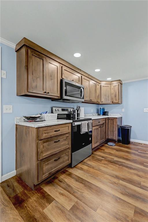 134 Church Road Thomaston, GA 30286 - Photo 8 of 33 a kitchen with stainless steel appliances kitchen island granite countertop a stove and cabinets