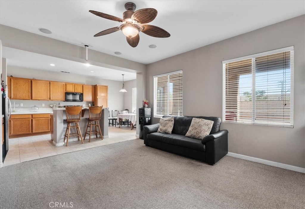1474 Albillo Loop Perris, CA 92571 - Photo 9 of 35 a living room with furniture and a large window