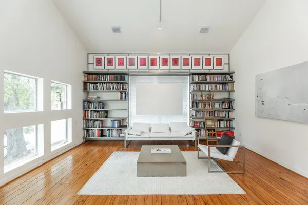 a living room with furniture and a book shelf