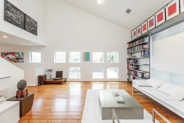 a living room with furniture and a book shelf